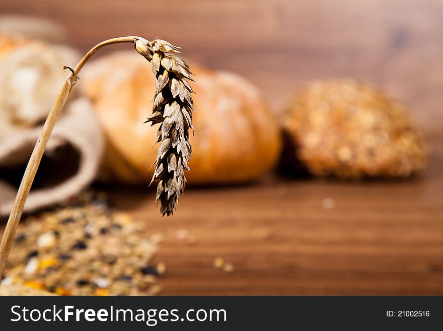 Composition of fresh bread on wooden background