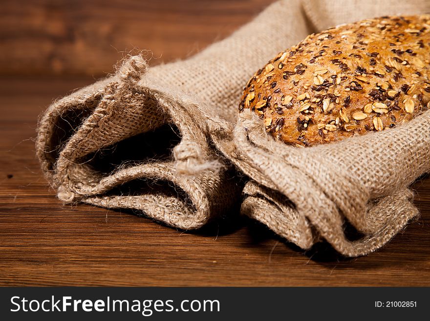 Composition of fresh bread on wooden background