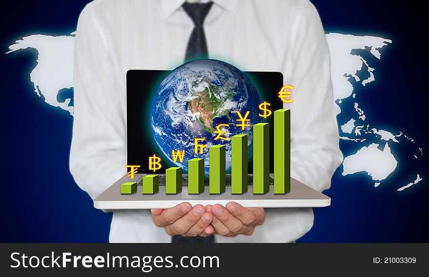 Businessman holding laptop with currency graph and small world
