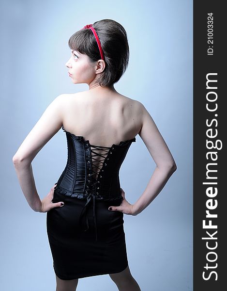 Woman is back in a black corset. Woman is back in a black corset
