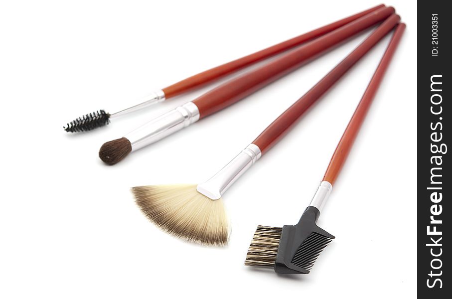 Makeup brushes on a white background