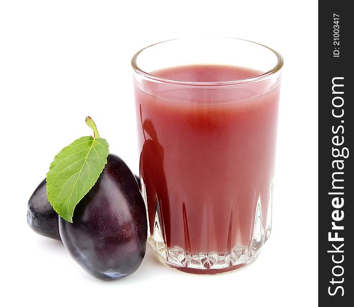 Glass of juice with plums on a white background