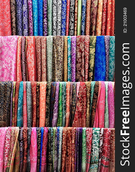 Colorful scarves hanging on racks