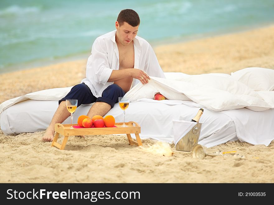 Young man finding an apple in bed at the coastline. Young man finding an apple in bed at the coastline