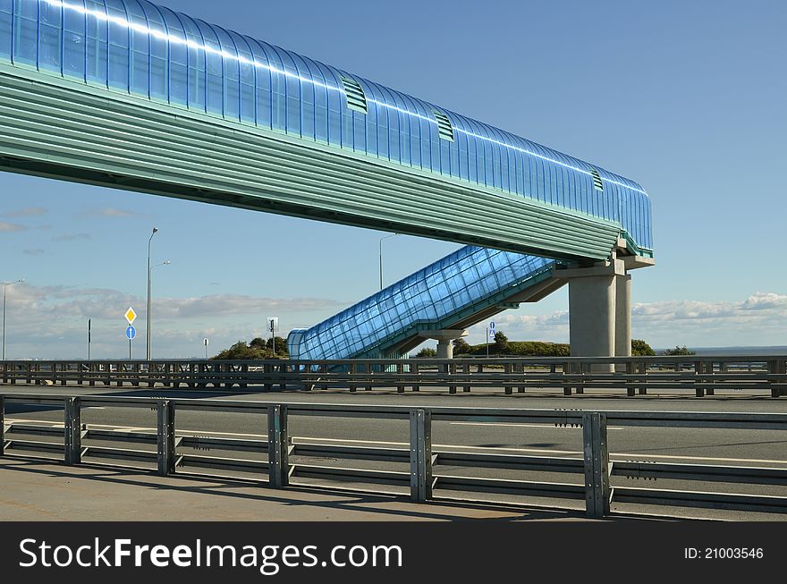 About a dark blue elevated pedestrian crossing