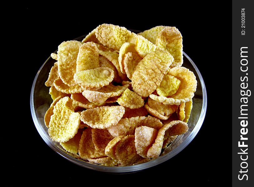 Cornflakes closeup on black background