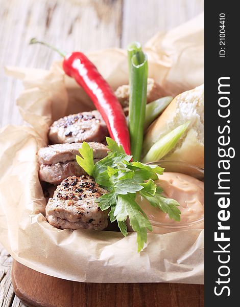 Roast pork tenderloin with bread roll and dipping sauce