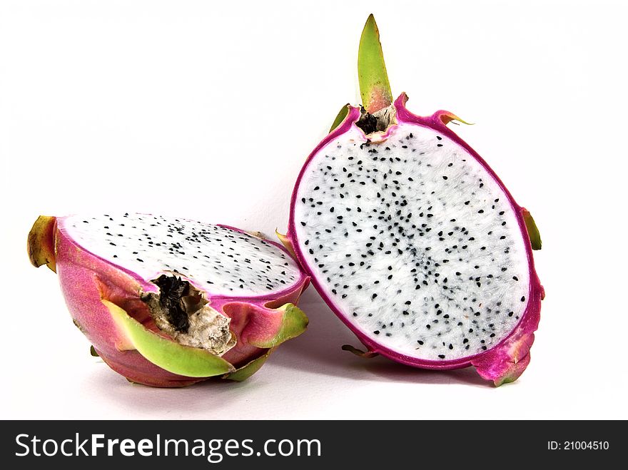 A cut of dragon fruit shot on white background. A cut of dragon fruit shot on white background.