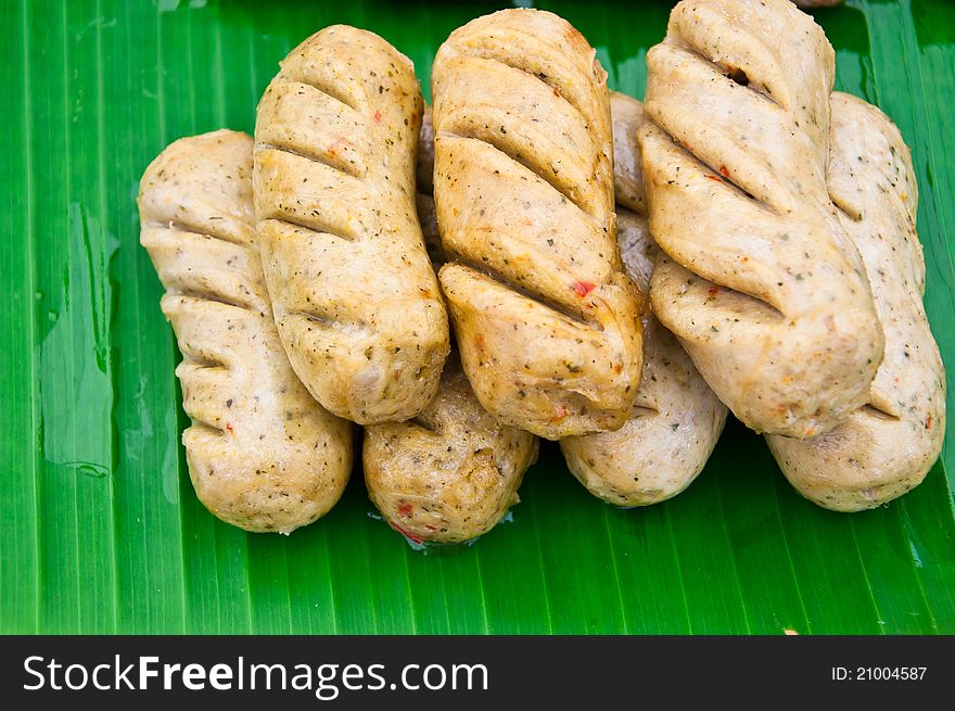 The Sausages On Banana Leaves Background