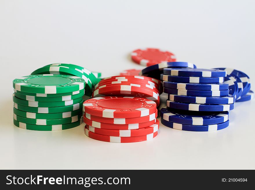 Three short stacks of colorful poker chips.