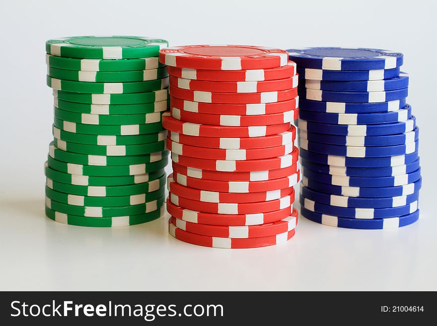 Three tall stacks of colorful poker chips.