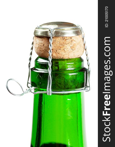 Close-up view of champagne bottle with cork isolated over white