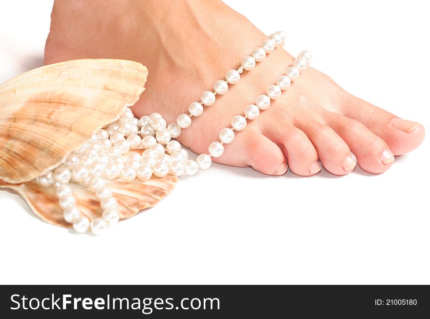 Feet and seashell on a white background