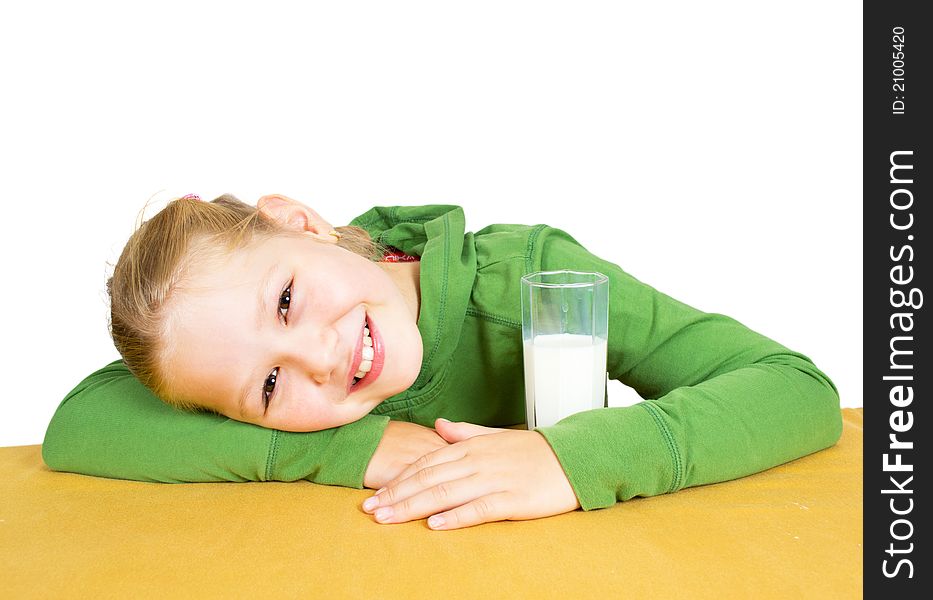 Happy little girl with a glass of milk, isolated over white