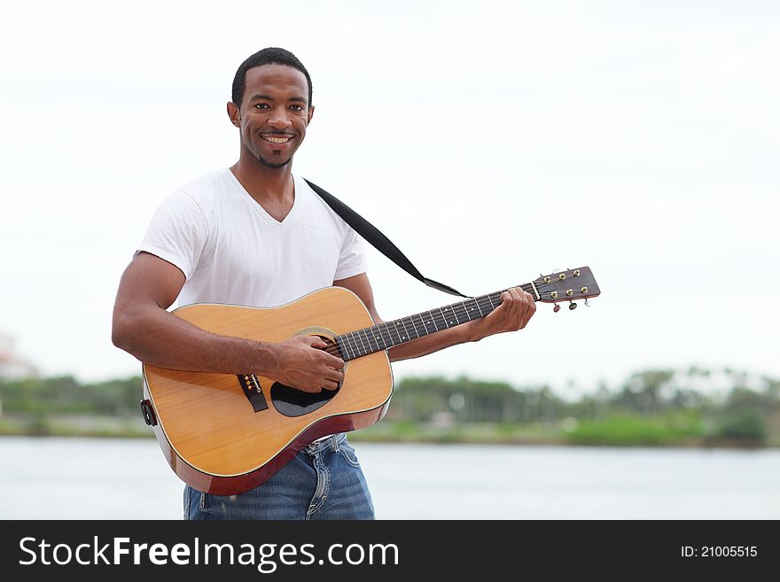 Image of a handsome black man with a guitar. Image of a handsome black man with a guitar
