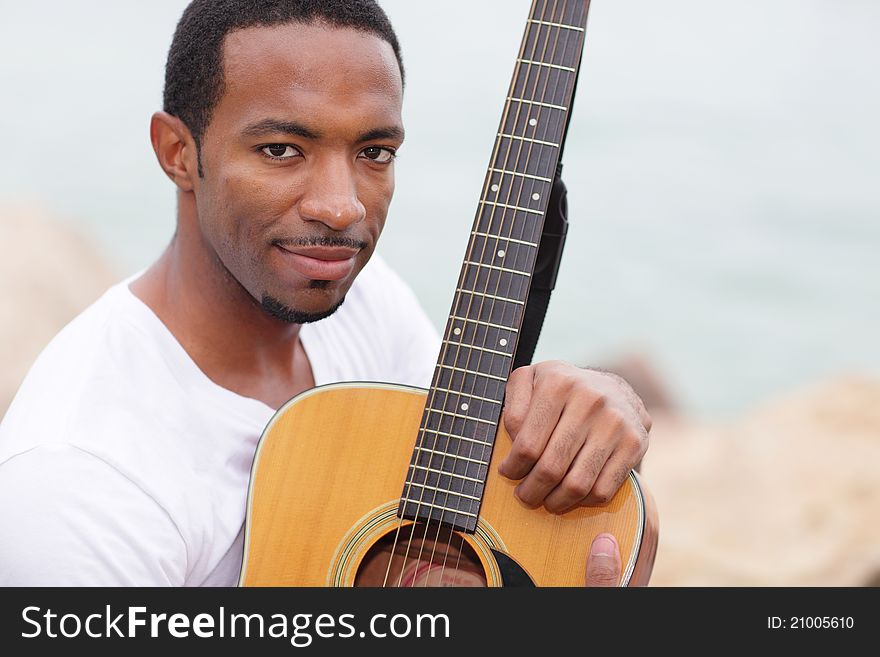 Image of a young black man with a guitar. Image of a young black man with a guitar