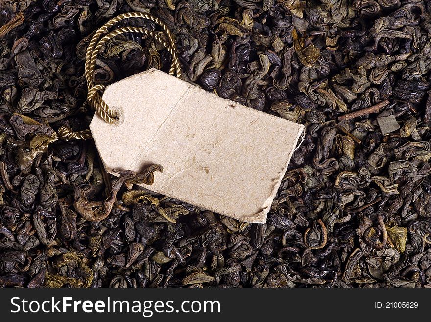 Macro photo of green tea leaves and paper label