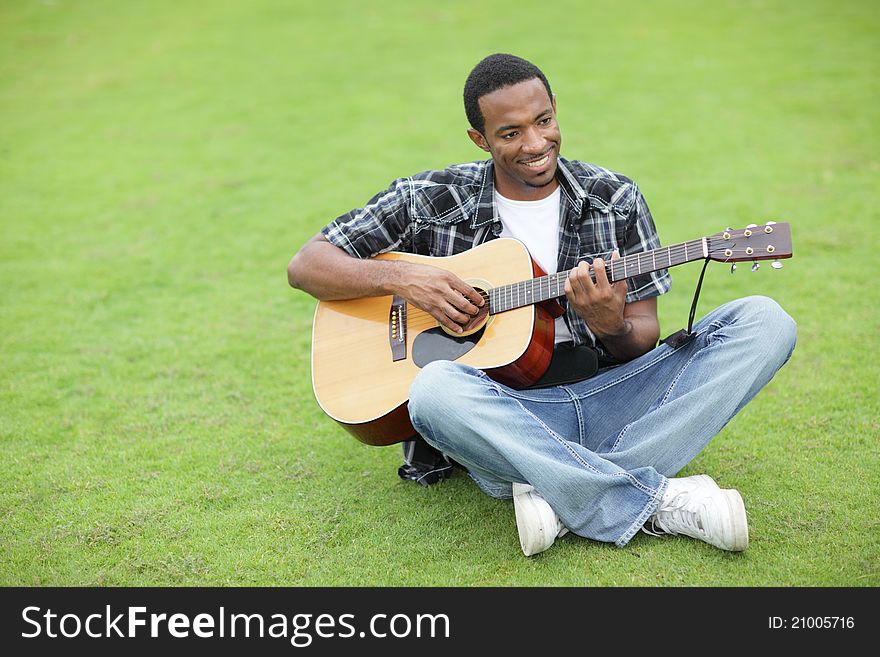 Man playing guitar in the park