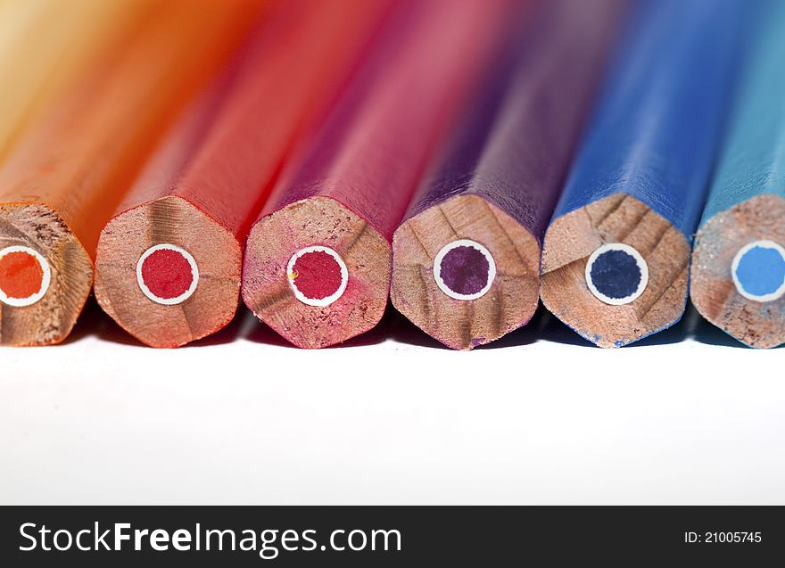 Manycolored pencils on the white background. Space for your text. Manycolored pencils on the white background. Space for your text
