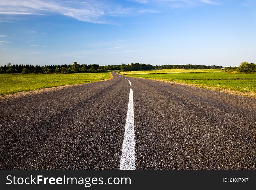 The small asphalted road passing in countryside. The small asphalted road passing in countryside