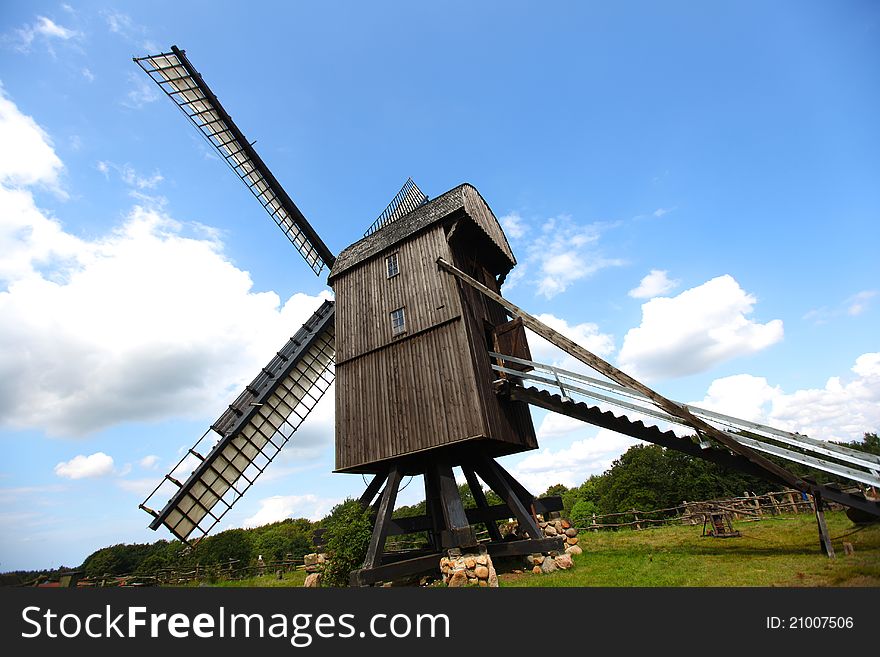 Old wooden windmill with sails for milling grain, medieval. Old wooden windmill with sails for milling grain, medieval