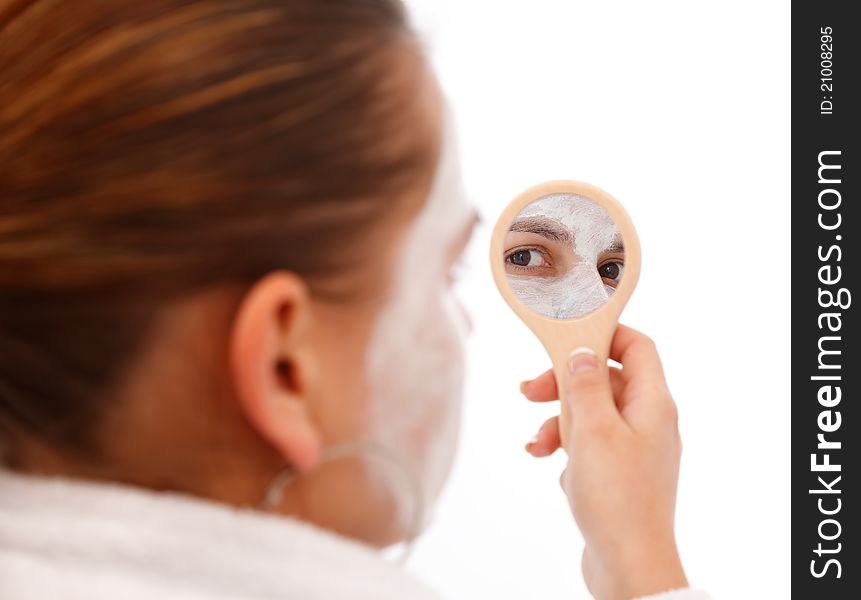 Young woman looking at the beauty mirror. Young woman looking at the beauty mirror