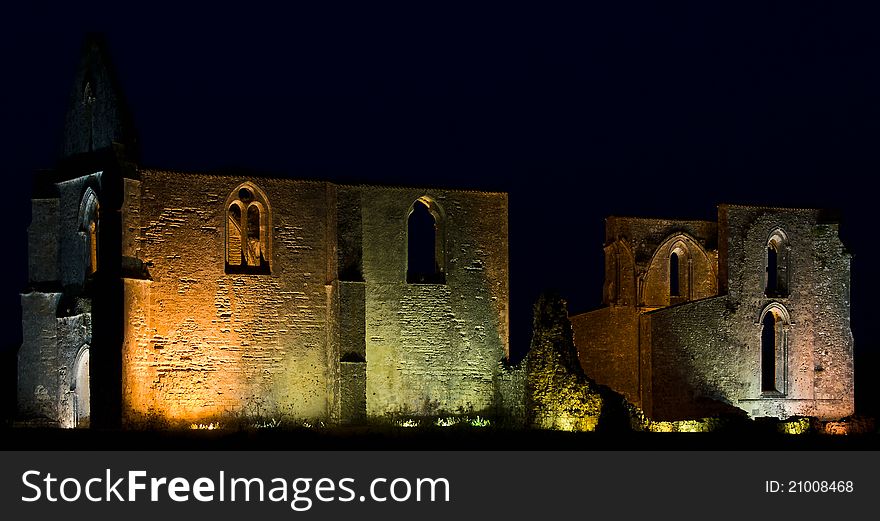 Illuminated ruins of an ancient cathedral.