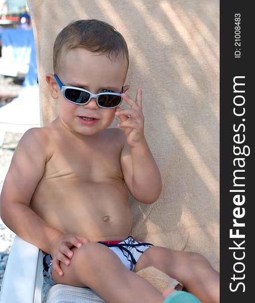 Kid with sunglasses on the beach. Kid with sunglasses on the beach