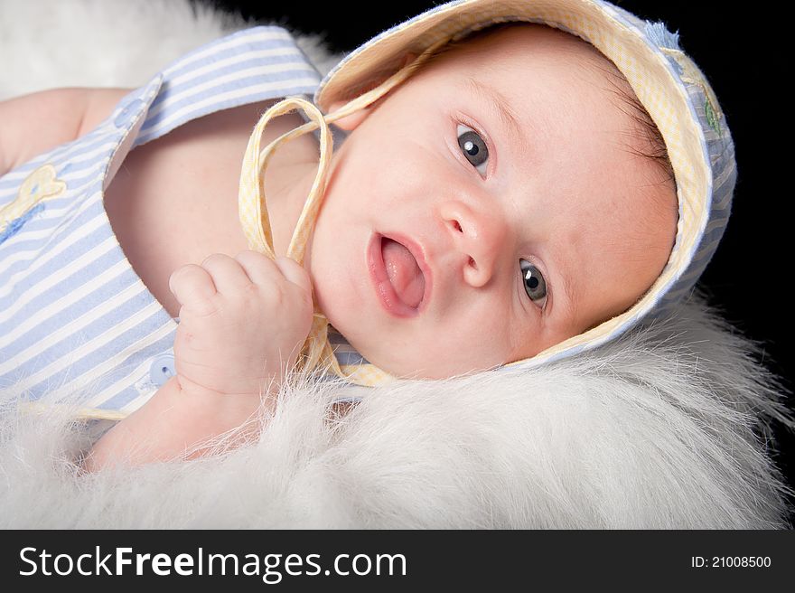 Curious baby boy in hat with mouth open