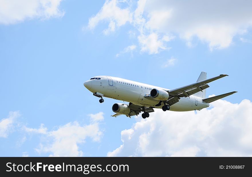 Landing passenger airliner in blue sky. Landing passenger airliner in blue sky