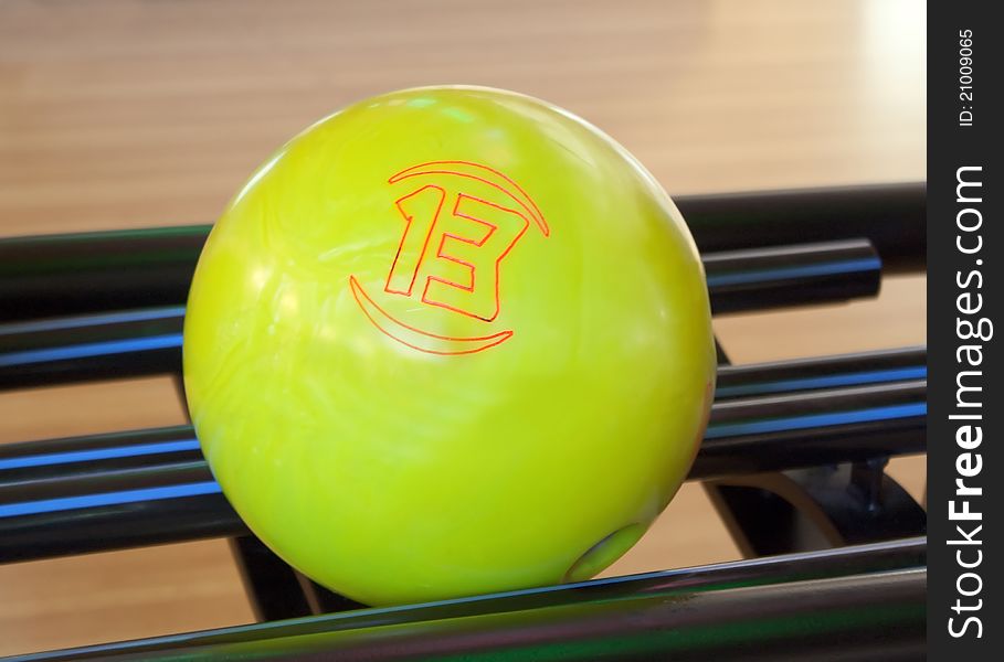 Yellow bowling ball number thirteen closeup