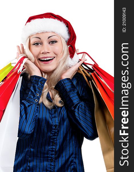 Portrait of a Christmas woman in santa hat holding a shopping bags over white background. Portrait of a Christmas woman in santa hat holding a shopping bags over white background