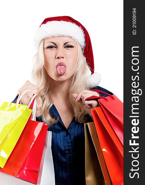 Portrait of a Christmas woman in santa hat holding a shopping bags over white background. Portrait of a Christmas woman in santa hat holding a shopping bags over white background