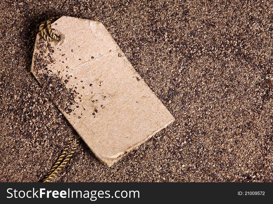 Closeup of ground black pepper with a label on a shoestring. Closeup of ground black pepper with a label on a shoestring