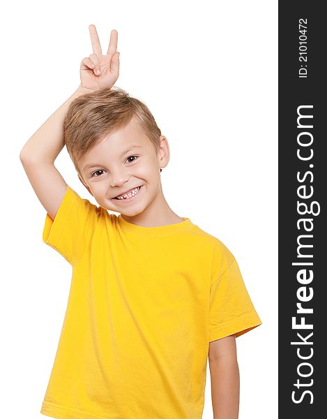 Portrait of little boy keeping two fingers above head over white background. Portrait of little boy keeping two fingers above head over white background