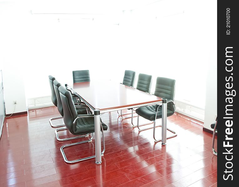 Interior of board room with conference table and comfortable chairs