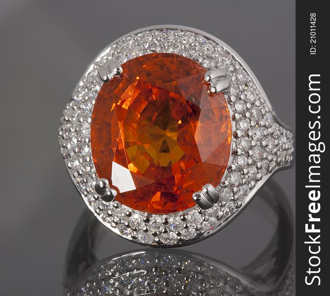 An Orange Garnet and Diamonds ring set in gold