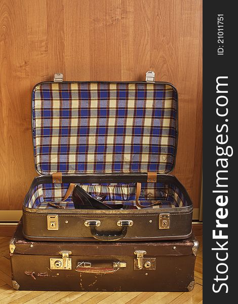 Old suitcases sacked on one another with modern shoe retro style in interior, concept for packing before travel. Old suitcases sacked on one another with modern shoe retro style in interior, concept for packing before travel