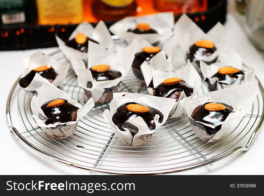 Mini muffins with chocolate and almonds on a metal rack