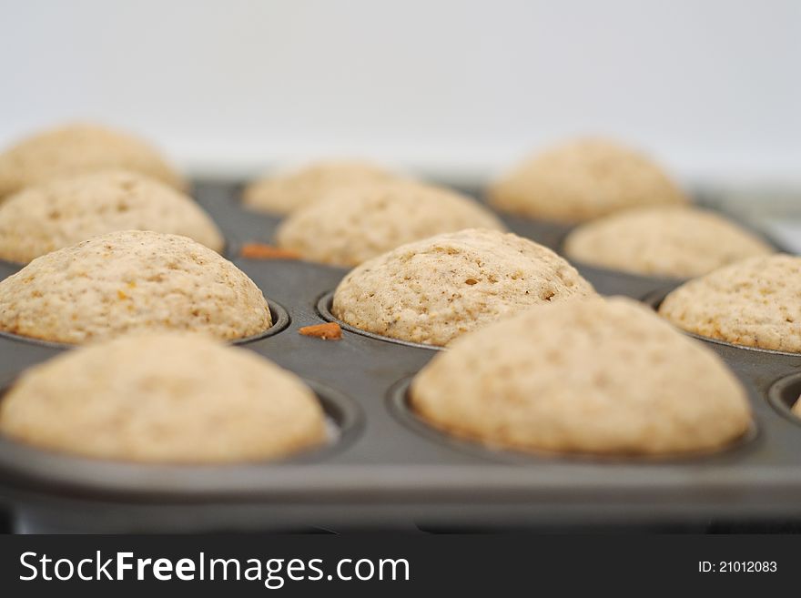 Freshly baked vanilla muffins resting in the tray