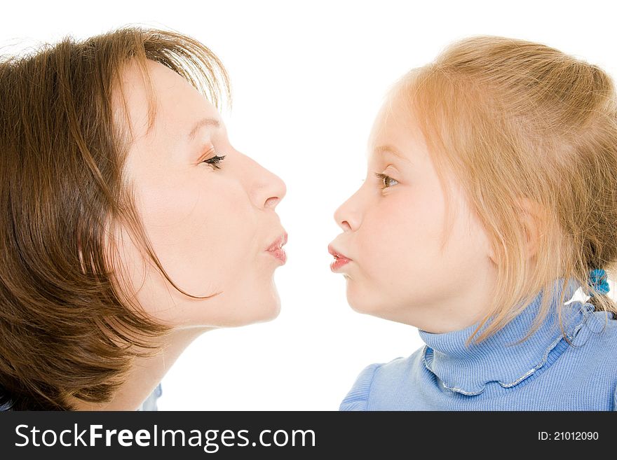 Mom and daughter kissing a white background. Mom and daughter kissing a white background.