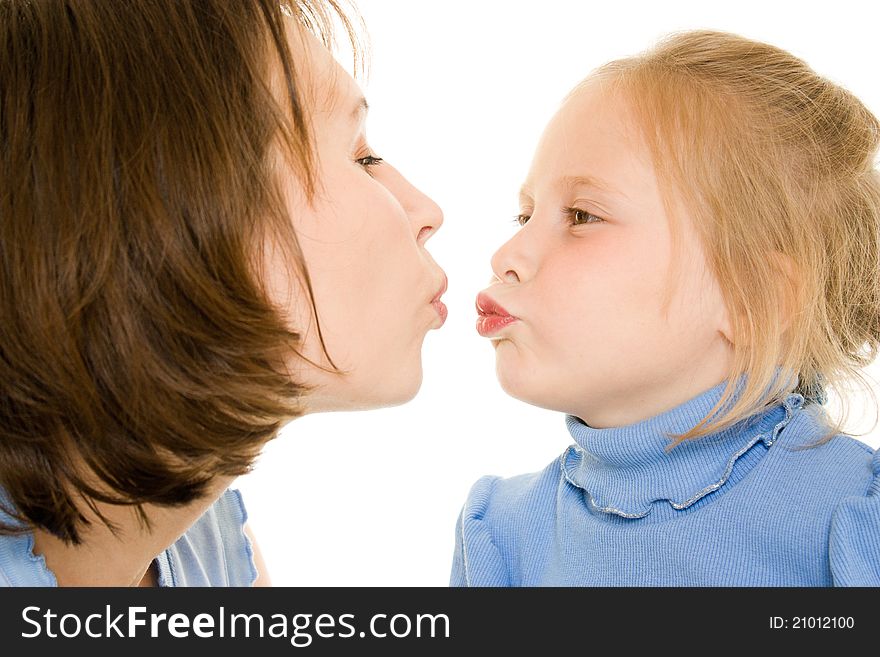 Mom and daughter kissing a white background. Mom and daughter kissing a white background.