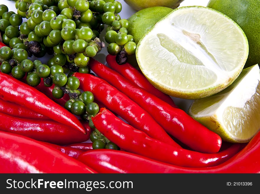 Mix food ingredient chili peppercone and lime on the white background. Mix food ingredient chili peppercone and lime on the white background