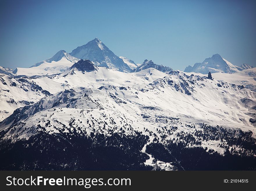 Top of mountains in blue sky