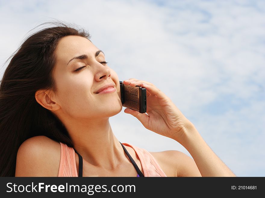 Young woman talking on the phone outdoors