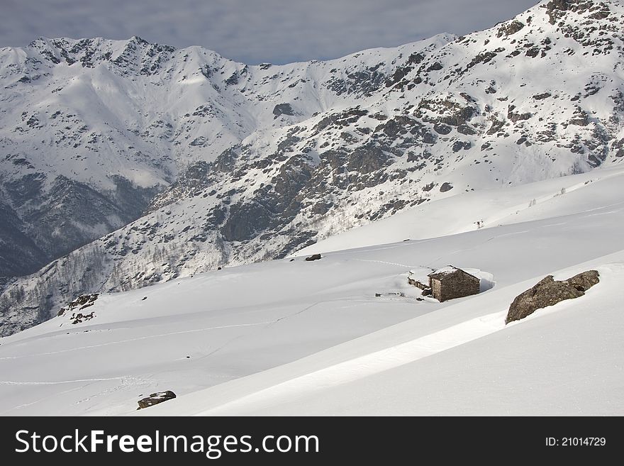 With Snowy Mountain Huts In The Alps