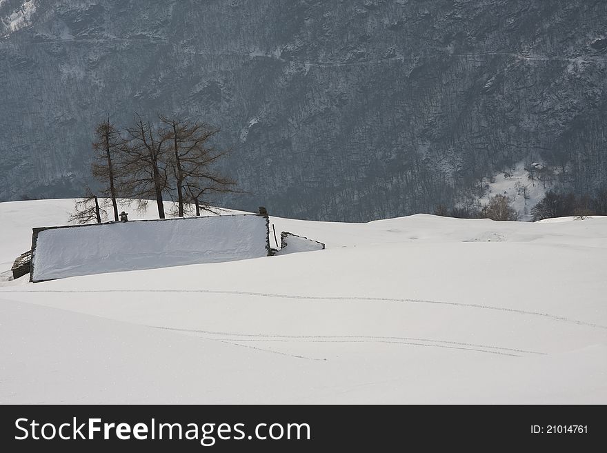 Mountain cabin in the snow in the Alps