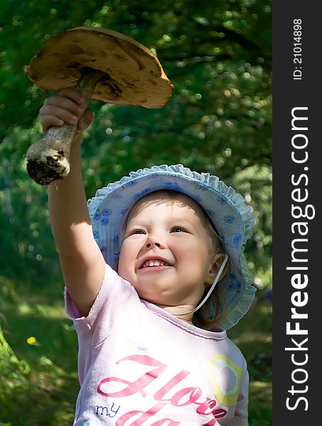 Little girl holding a big mushroom. Little girl holding a big mushroom