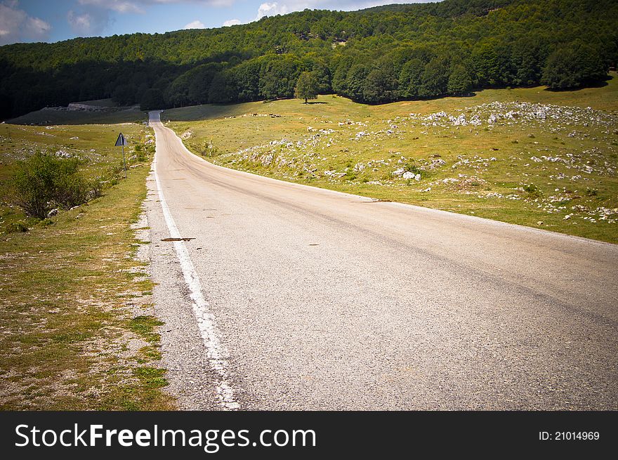 Lower view of a country road that run through hills. Lower view of a country road that run through hills