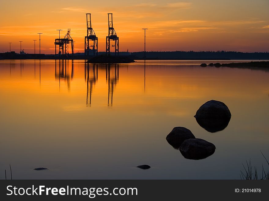 Harbor cranes in early summer morning dawn. Harbor cranes in early summer morning dawn